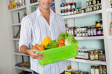 Image showing Man With Basket Of Fresh Vegetables Standing In Store