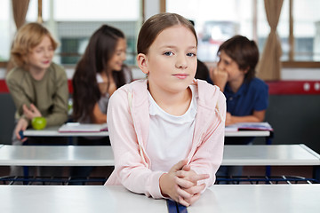 Image showing Little Schoolgirl Leaning At Desk