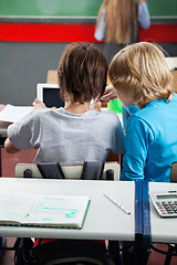 Image showing Schoolboys Using Digital Tablet At Desk