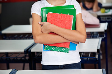 Image showing Midsection Of Schoolgirl Holding Books