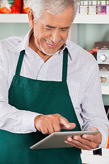 Image showing Owner Using Digital Tablet In Grocery Store