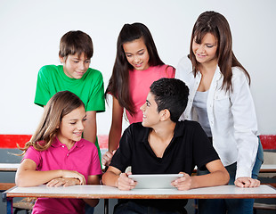 Image showing University Students Using Digital Tablet At Desk