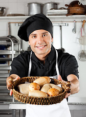 Image showing Male Chef Offering Breads In Kitchen