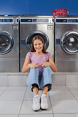 Image showing Woman Sitting Against Washing Machines At Laundry