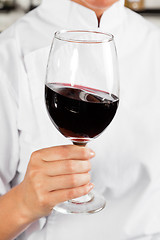 Image showing Chef Holding Glass Of Red Wine