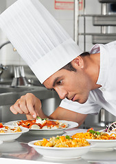 Image showing Chef Garnishing Pasta Dishes