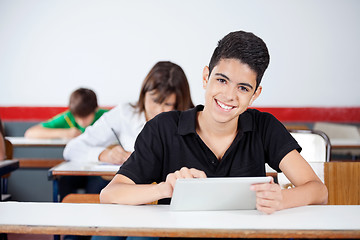 Image showing Male University Student Using Digital Tablet At Desk