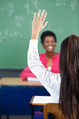 Image showing Teenage Girl Raising Hand At Desk