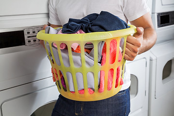 Image showing Man Carrying Laundry Basket