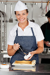 Image showing Happy Chef Preparing Chocolate Roll