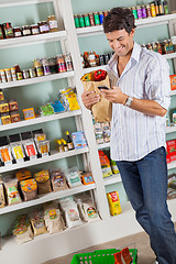 Image showing Man With Grocery Bag Checking List In Supermarket