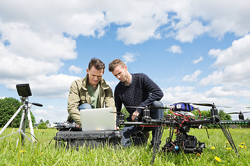 Image showing Technicians Working On Laptop By UAV in Park