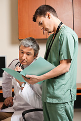 Image showing Technician Showing Report To Doctor