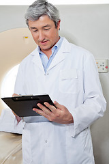 Image showing Doctor Writing On Clipboard