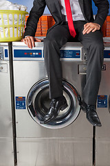 Image showing Businessman Sitting On Washing Machine