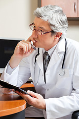 Image showing Thoughtful Doctor At Desk