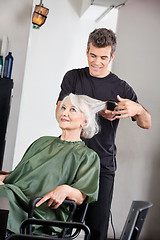 Image showing Hairstylist Straightening Female Client's Hair