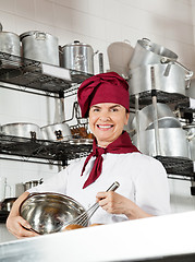 Image showing Female Chef Mixing Egg With Wire Whisk In Bowl