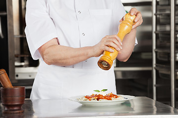 Image showing Female Chef With Peppermill Seasoning Dish