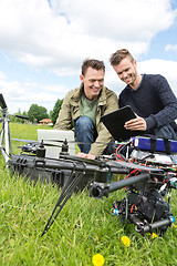 Image showing Technicians Discussing Over Digital Tablet By UAV