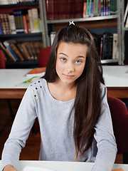 Image showing Portrait Of Female Student Sitting In Library