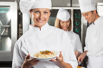 Image showing Happy Female Chef Presenting Dish