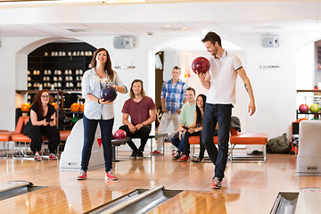 Image showing Man And Woman Holding Bowling Balls in Club