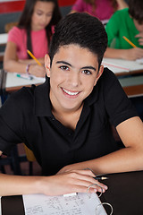 Image showing High School Student Smiling While Sitting At Desk