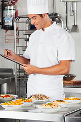 Image showing Male Chef With Clipboard Checking List Of Pastas