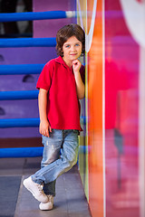 Image showing Boy With Hand On Chin Leaning On Wall