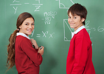 Image showing Portrait Of Teenage School Students Standing Against Board