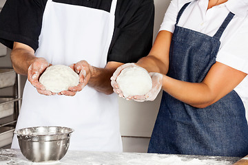 Image showing Chefs Presenting Dough In Kitchen