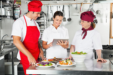 Image showing Chefs Using Tablet Computer In Kitchen