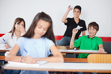 Image showing Schoolboys Throwing Paperplane And Paperball On Girl