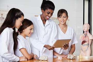 Image showing Teacher With Teenage Girls Using Digital Tablet At Desk