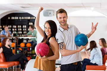 Image showing Excited Man And Woman Holding Bowling Balls