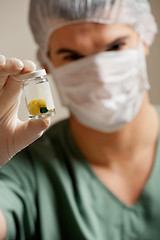 Image showing Surgeon Holding Pill Bottle