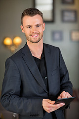 Image showing Businessman Holding Digital Tablet At Cafe