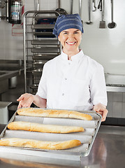 Image showing Female Chef Presenting Loafs Of Bread