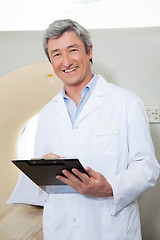 Image showing Happy Doctor Holding Clipboard