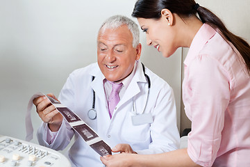 Image showing Doctor And Patient Looking At Ultrasound Print