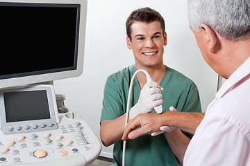 Image showing Happy Technician Scanning Male Patient's Hand