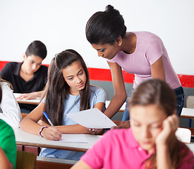 Image showing Teacher Showing Paper To Teenage Girl During Examination