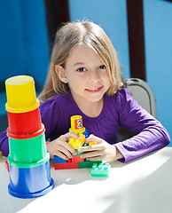 Image showing Girl Sitting With Toys At Desk In Preschool