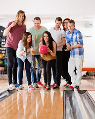 Image showing Woman Bowling While Friends Cheering