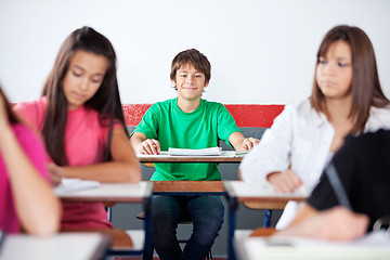 Image showing Teenage Schoolboy Sitting In Classroom