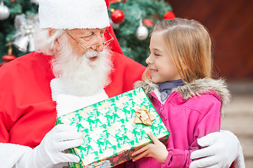 Image showing Santa Claus Giving Christmas Present To Girl