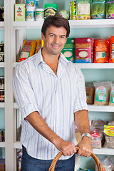 Image showing Portrait Of Man With Basket In Grocery Store