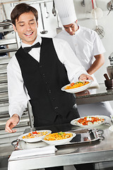 Image showing Waiter Holding Pasta Dish