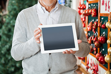 Image showing Man Holding Digital Tablet At Christmas Store